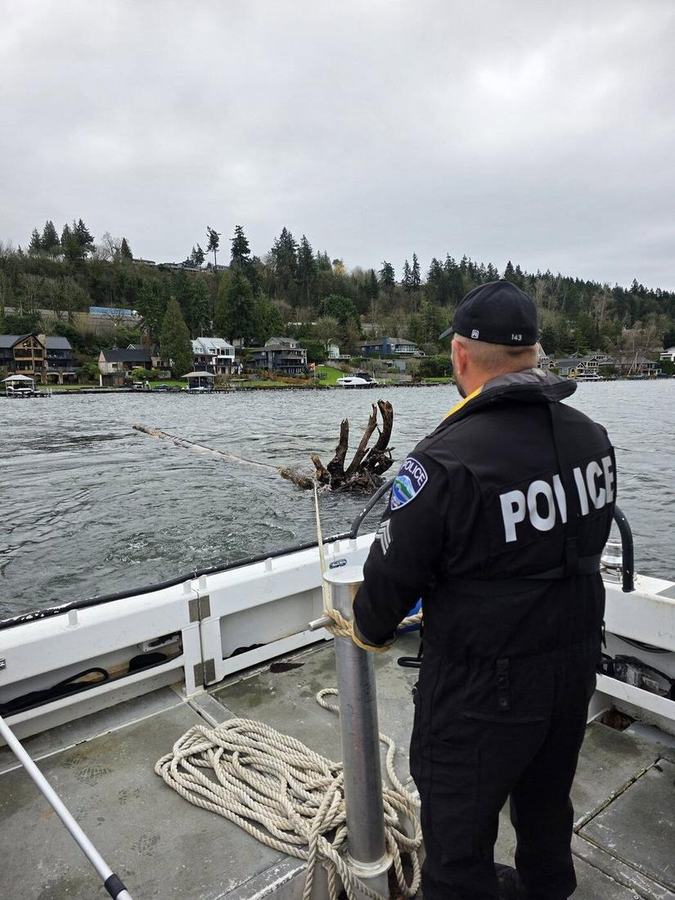 MIPD marine officer hauling a line aboard the patrol boat