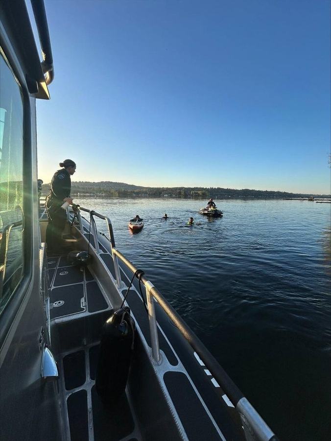 MIPD marine officer watching a water rescue from the patrol boat